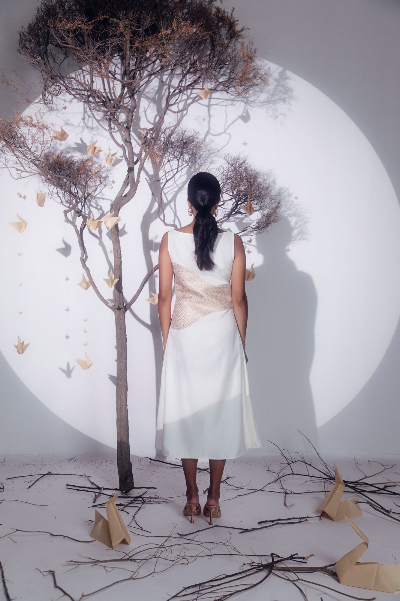 Butter-white silk dress in luxurious handloom fabric, showcasing a graceful silhouette, epitomizing artisan-crafted elegance in womenswear