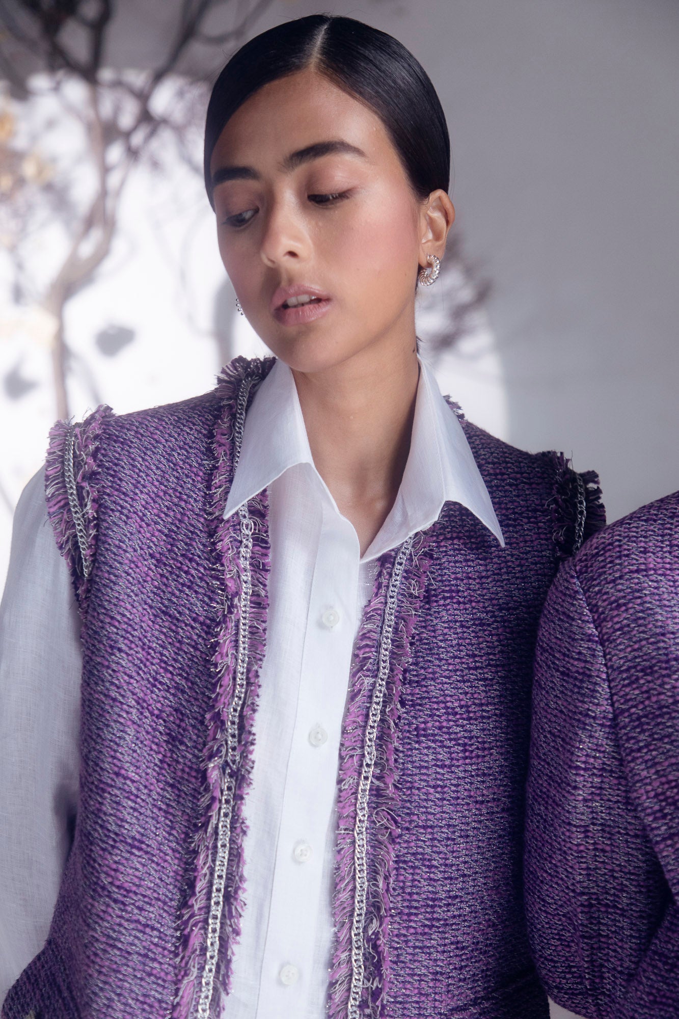 Purple boucle sleeveless jacket with chain detail, crafted from pure woolen herringbone and silk taffeta, exemplifying luxury womenswear
