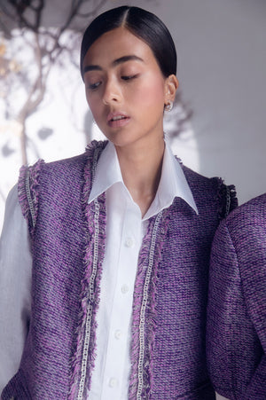 Purple boucle sleeveless jacket with chain detail, crafted from pure woolen herringbone and silk taffeta, exemplifying luxury womenswear