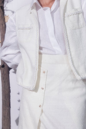 Pearl-white handcrafted jacket in premium fabric, showcasing luxury womenswear with elegant silhouette and artisan detailing