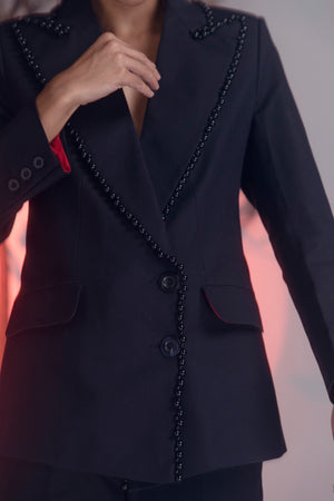 Jet-black pearl suit in premium handloom fabric, showcasing exquisite craftsmanship and luxury womenswear elegance by NJ3 Atelier