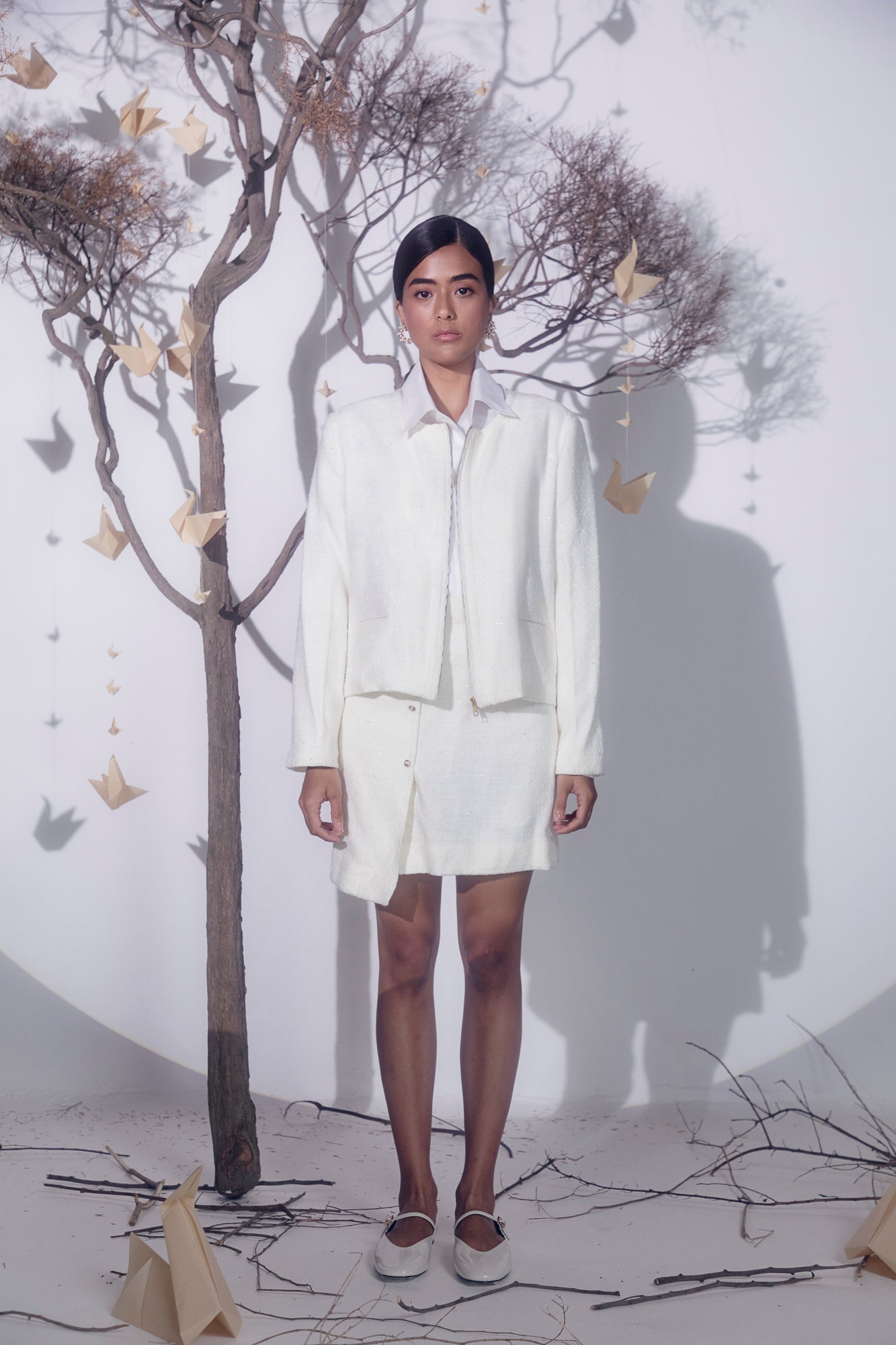 White boucle jacket featuring a delicate lace zipper, crafted from a cotton lurex mix, exemplifying luxury womenswear craftsmanship