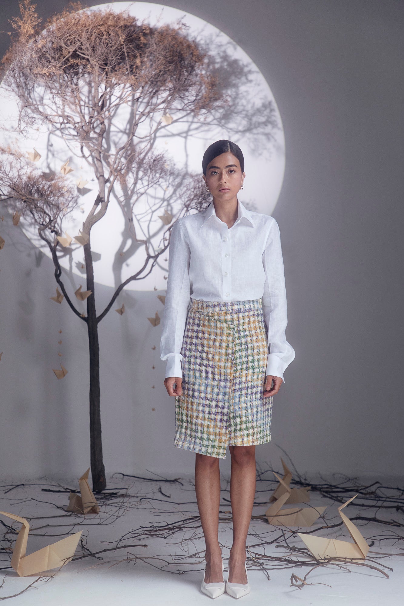 Luxurious multi-color boucle pencil skirt, artisan-made with premium fabric, showcasing a sophisticated midi silhouette for elegant style