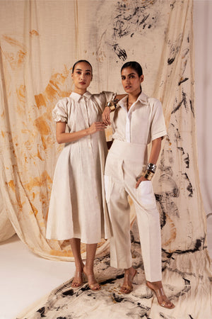 Beige linen dress with classic collar, lace seams, puff sleeves, and A-line silhouette; handcrafted luxury womenswear made in India