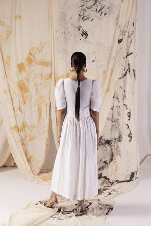 Elegant paper-white linen dress with button detail, showcasing handcrafted luxury and premium fabric, epitomizing NJ3 Atelier's artisan craftsmanship