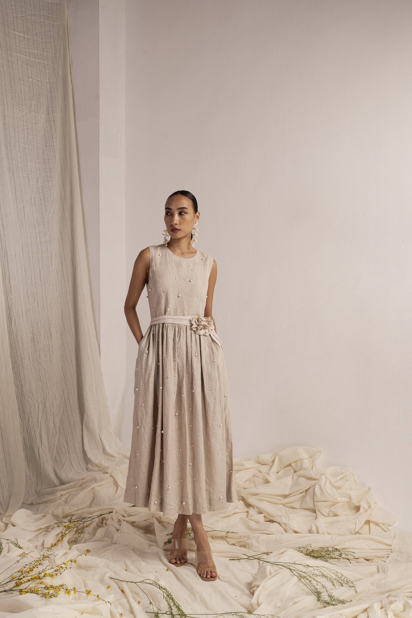 Elegant ivory linen dress with a flowing silhouette, handcrafted from premium fabric, embodying NJ3 Atelier's luxury womenswear craftsmanship
