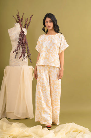 Luxurious beige linen co-ord set with floral print, featuring a dolman top and trousers, artisan-crafted with delicate lace detailing