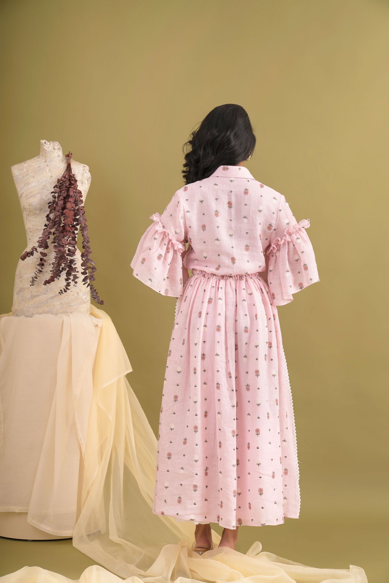 Elegant pink-coral dress in premium handloom fabric, showcasing a flowing silhouette, perfect for luxury womenswear enthusiasts
