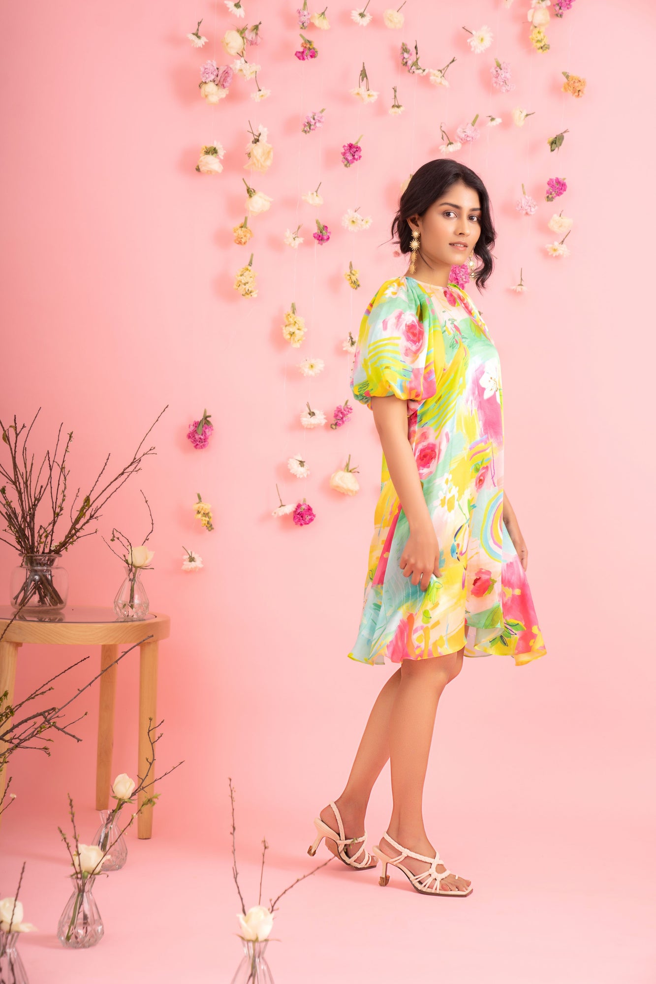 Elegant handcrafted short dress in premium fabric, showcasing a vibrant mix of colors and a chic silhouette, epitomizing luxury womenswear