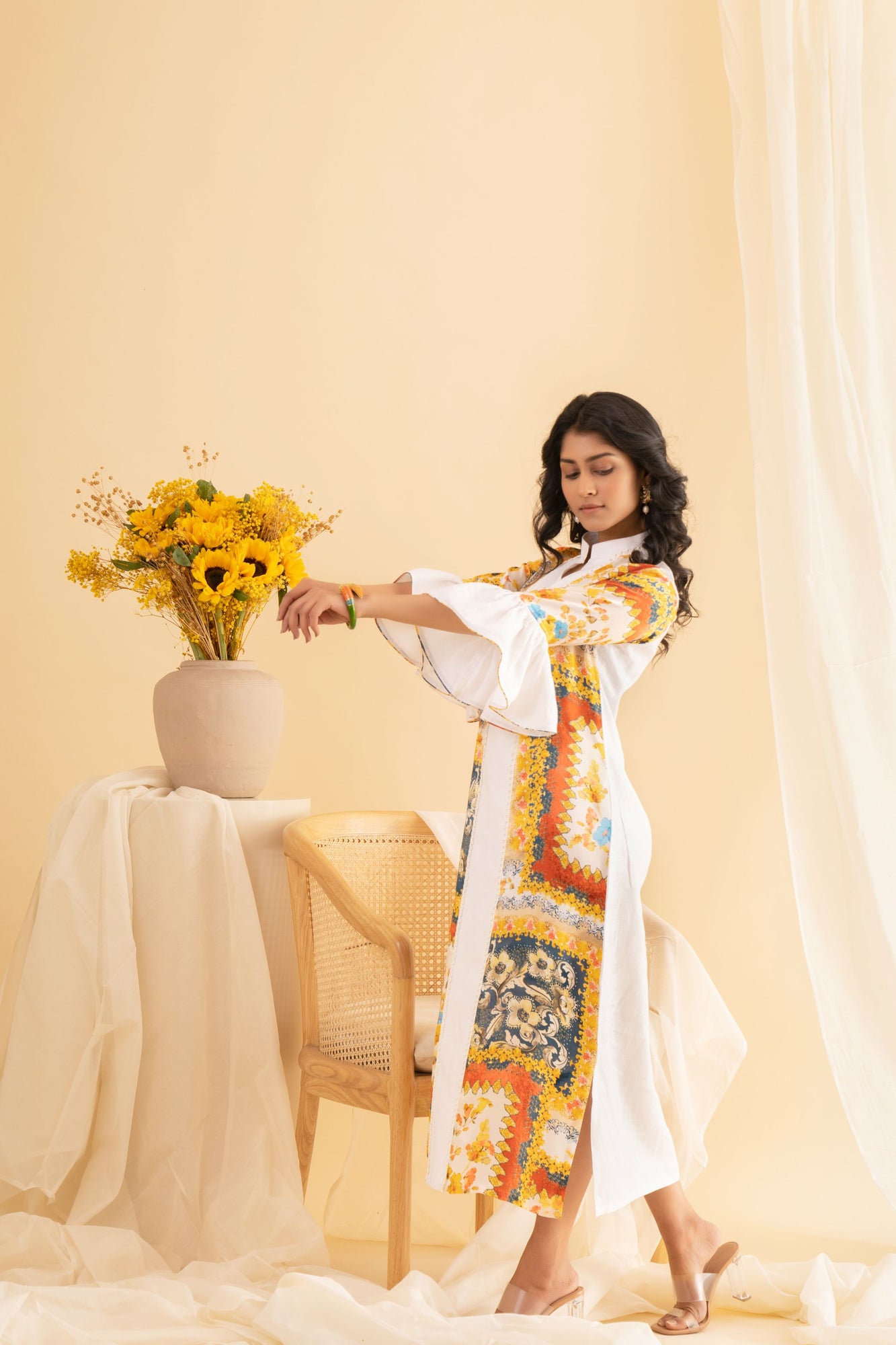 Luxurious multicolored midi dress in pure crepe silk, featuring a slit and ball cuff detail, showcasing vibrant orange, red, yellow, and blue hues