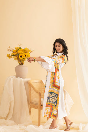 Luxurious multicolored midi dress in pure crepe silk, featuring a slit and ball cuff detail, showcasing vibrant orange, red, yellow, and blue hues