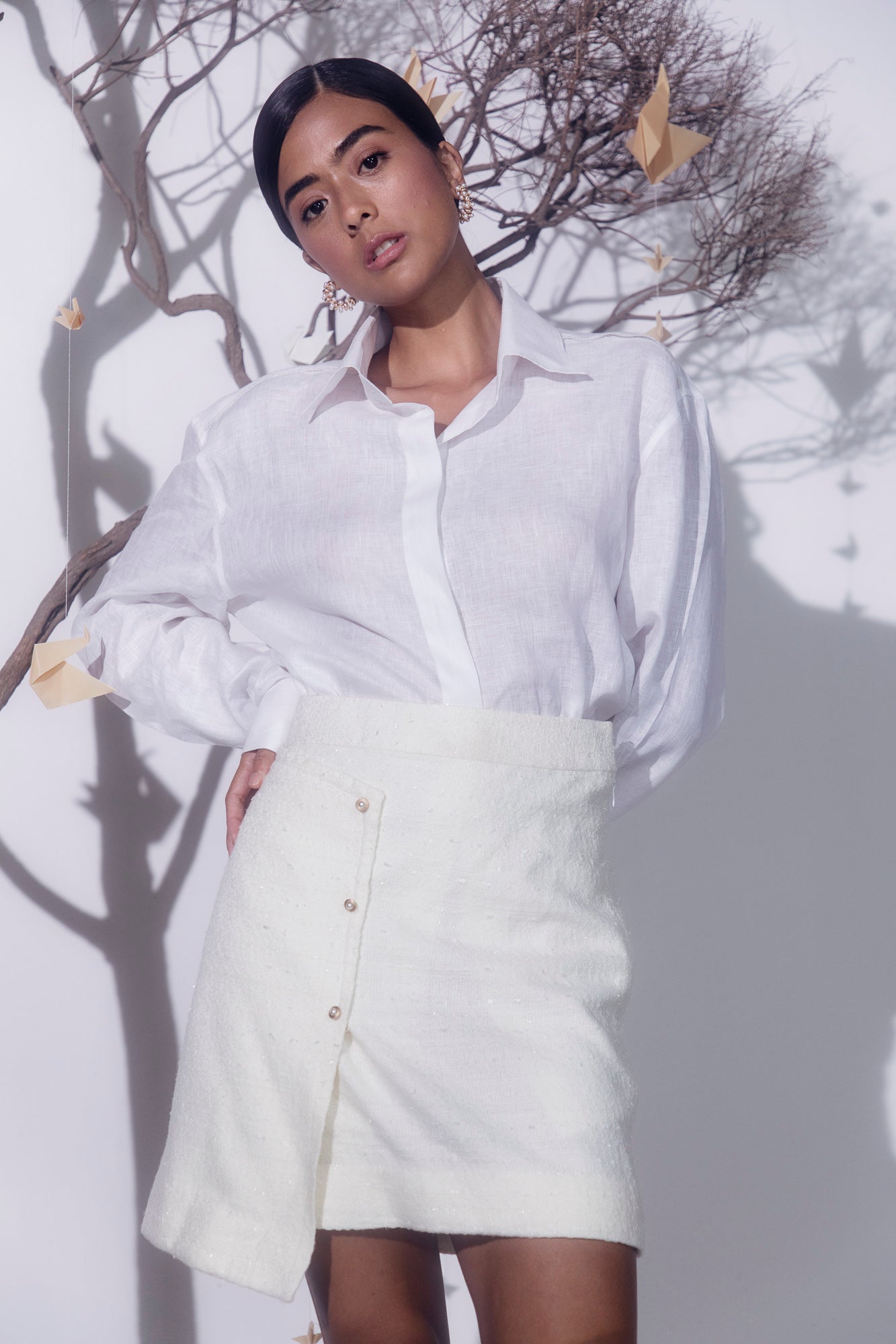 White midi skirt in luxe boucle cotton lurex blend, featuring elegant front buttons, tailored for a refined, sophisticated look