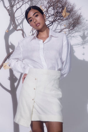 White midi skirt in luxe boucle cotton lurex blend, featuring elegant front buttons, tailored for a refined, sophisticated look