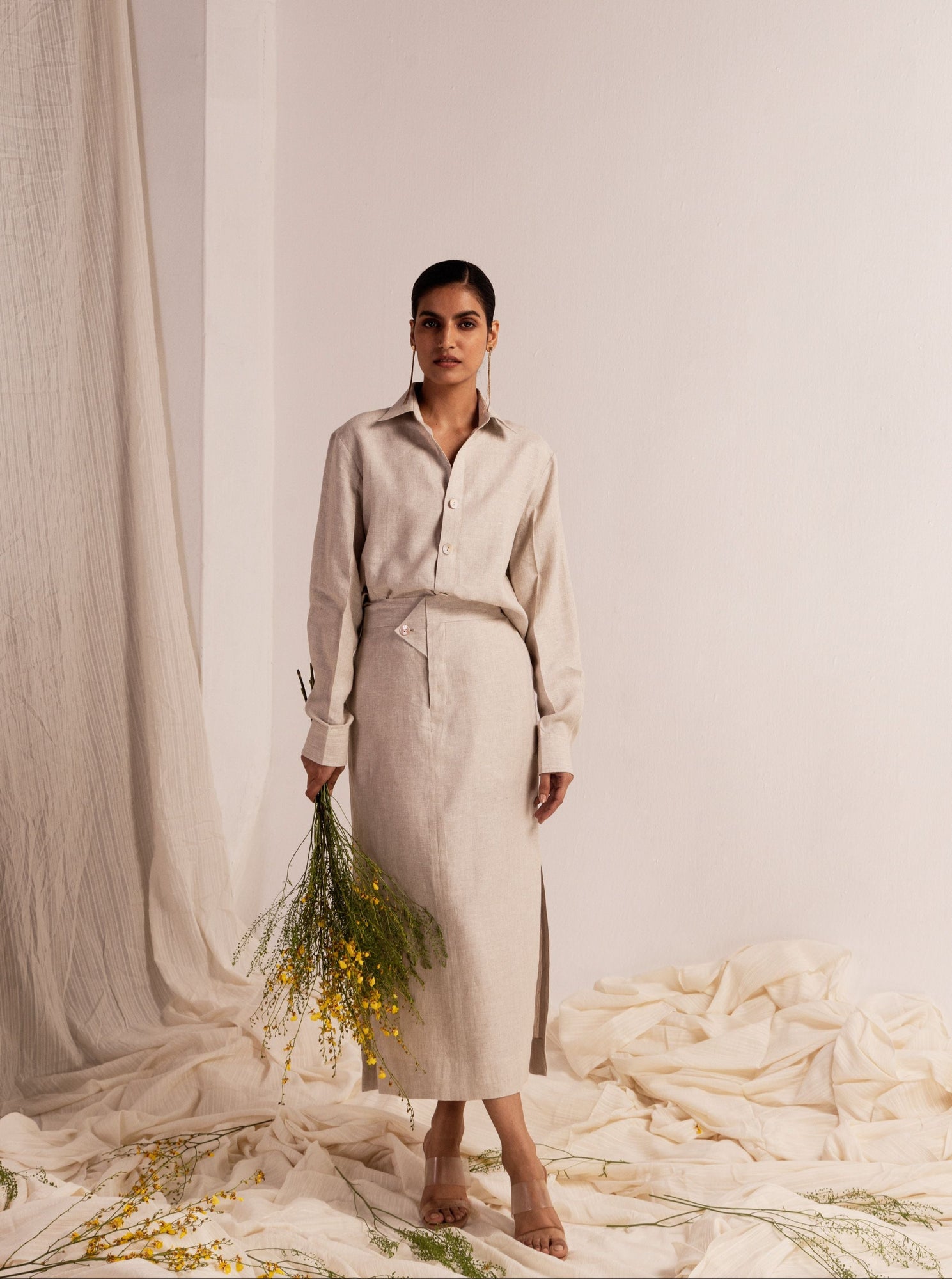 Elegant linen coord set with a classic collared shirt, full sleeves, and a pencil skirt featuring side slits, showcasing luxury womenswear craftsmanship