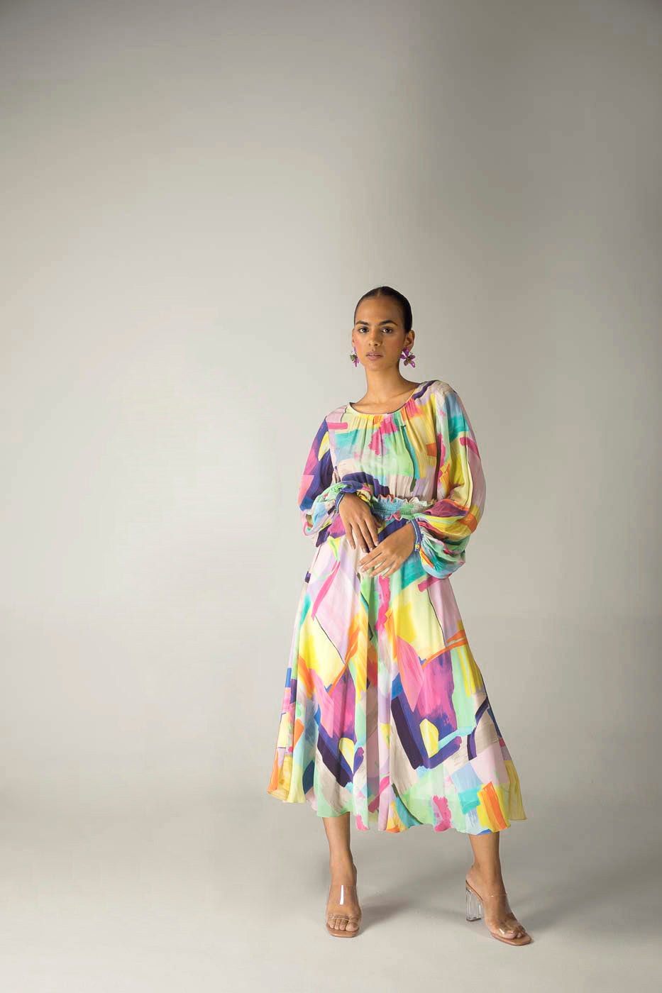 Elegant long dress in multi-color crepe silk, featuring a smocked base; a luxury womenswear piece, dry clean only