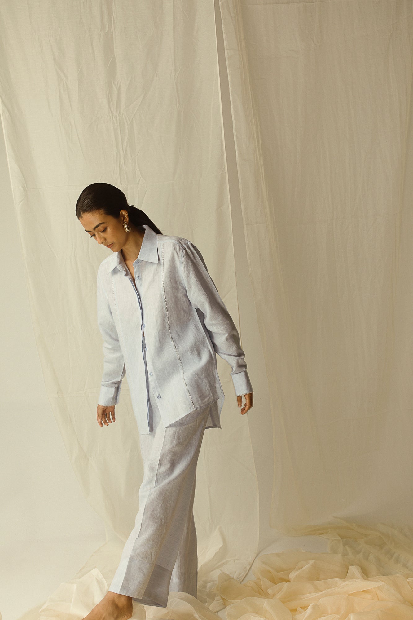 Elegant close-up of a handloom scallop hem shirt in premium fabric, showcasing artisan craftsmanship and luxury womenswear design