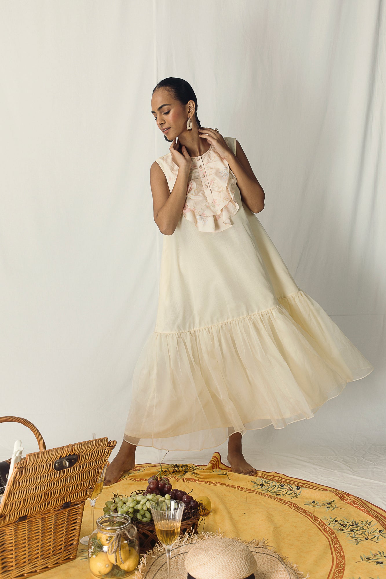 Elegant long yellow dress in pure cotton organza, featuring organza gathering at the bottom and pearl buttons, embodying luxury womenswear