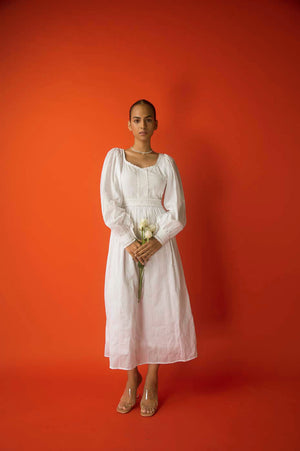 Elegant white midi dress in pure cotton with intricate lace inserts, showcasing luxury womenswear craftsmanship and artisan detailing