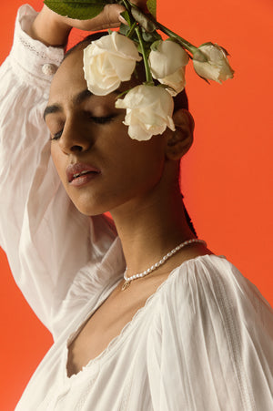 Close-up of the Bianca Cotton Midi Dress showcasing its luxurious handloom fabric and exquisite artisan craftsmanship in a soft ivory hue