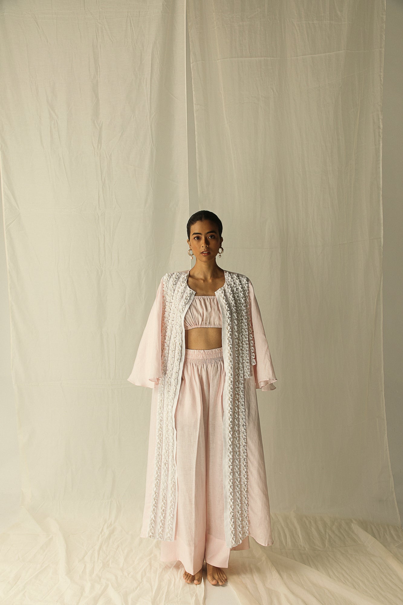 Luxurious hand-embroidered kaftan in pink and blue, showcasing origami technique on pure Italian linen, epitomizing artisan craftsmanship