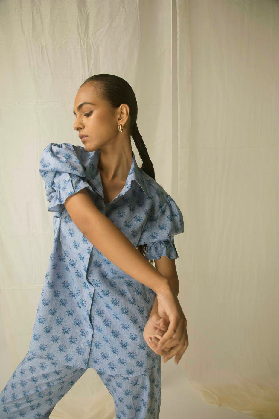 Blue linen shirt with Italian rose print, featuring elegant half puff sleeves; a luxurious, artisan-crafted piece for refined womenswear