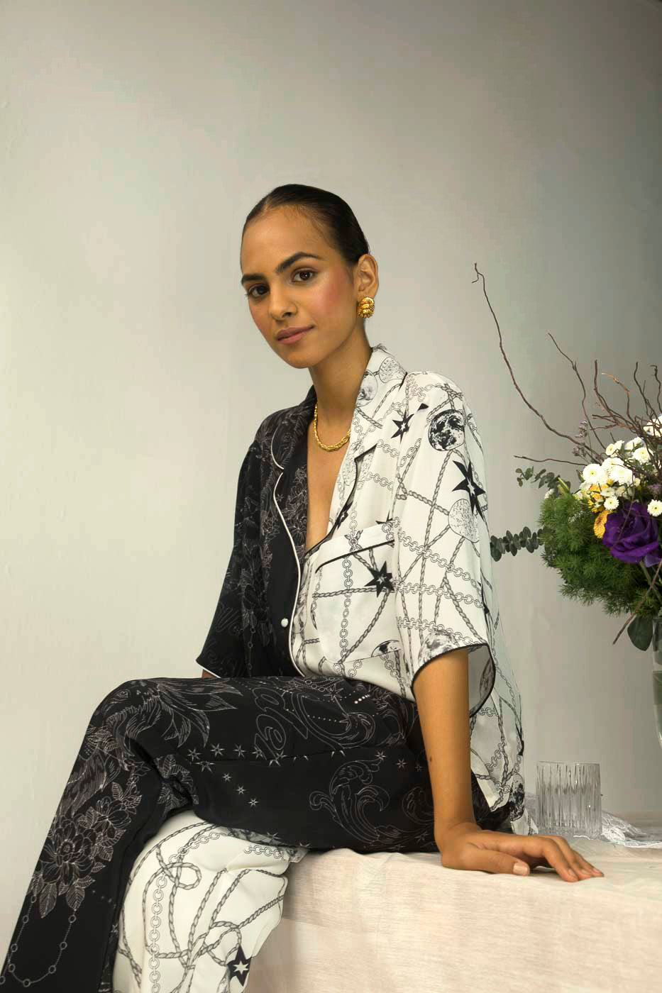 Luxurious black and white half-and-half top in pure crape silk, showcasing artisan craftsmanship and sophisticated design