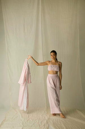 Loose-fit luxury trousers in pure Italian linen, showcasing vibrant pink, yellow, and blue hues, embodying artisan craftsmanship