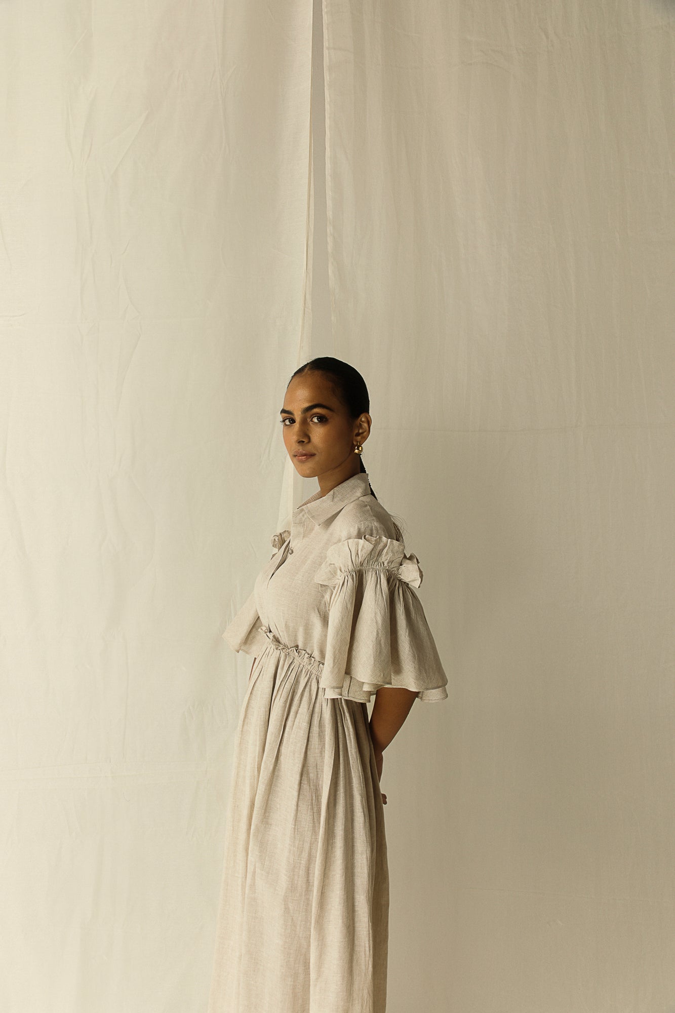 Manor Stone Dress in premium handloom fabric, showcasing a tailored silhouette with artisan-crafted details, epitomizing luxury womenswear