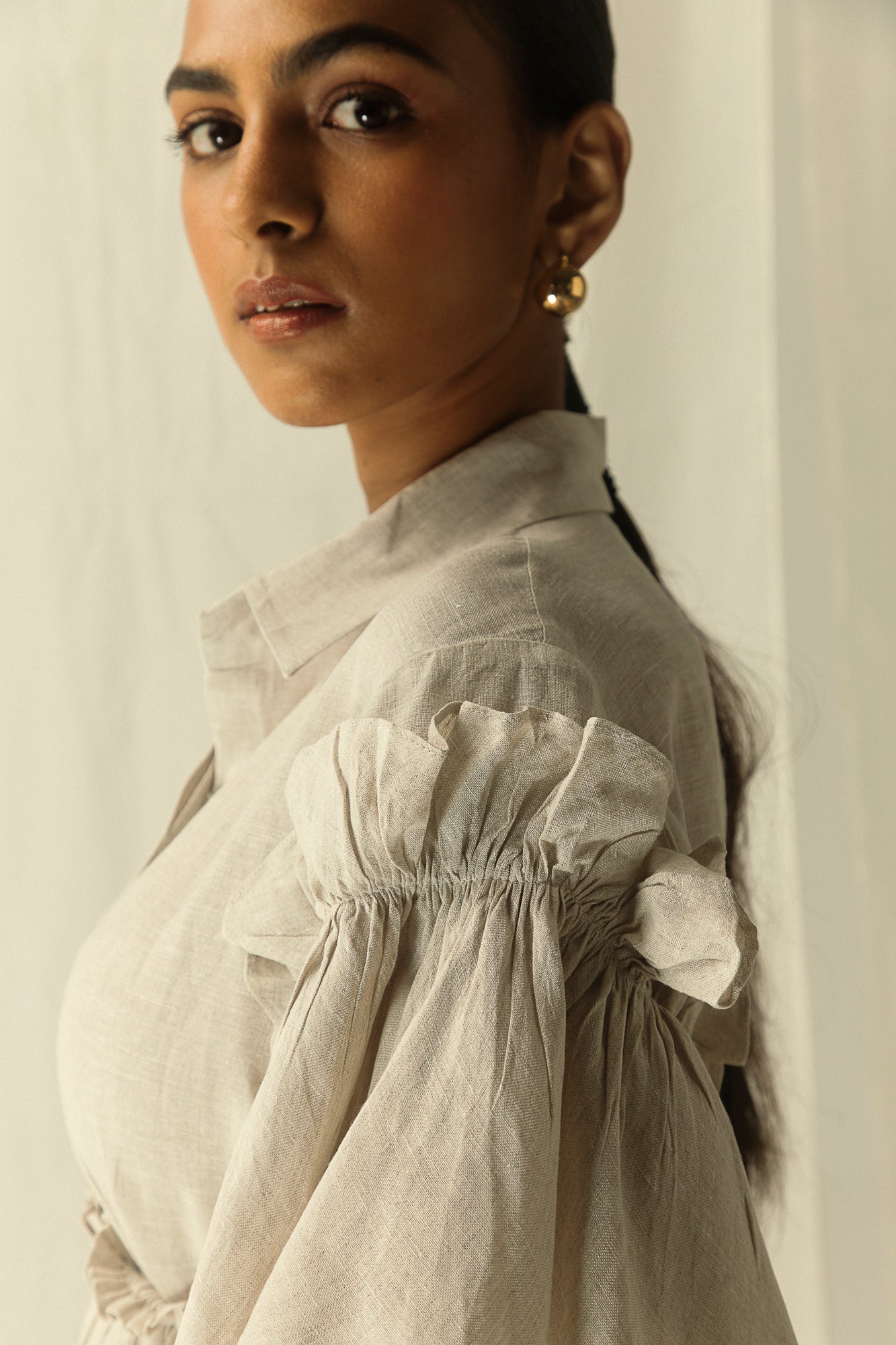 Elegant handcrafted stone-colored dress with a flowing silhouette, made from premium handloom fabric, epitomizing luxury womenswear