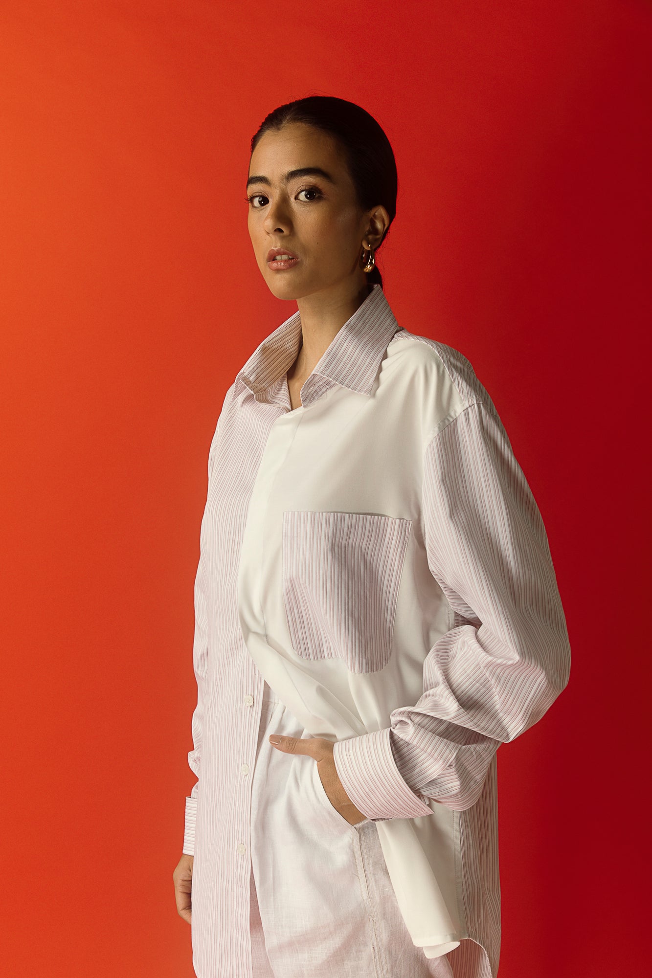Elegant women's shirt in pure Italian cotton, featuring a unique half pink stripe and half plain white design, exuding luxury and style