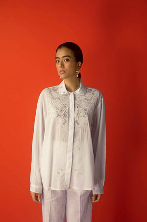 White Italian linen shirt featuring intricate laser-cut embroidery, showcasing NJ3 Atelier's luxury craftsmanship and sophisticated style