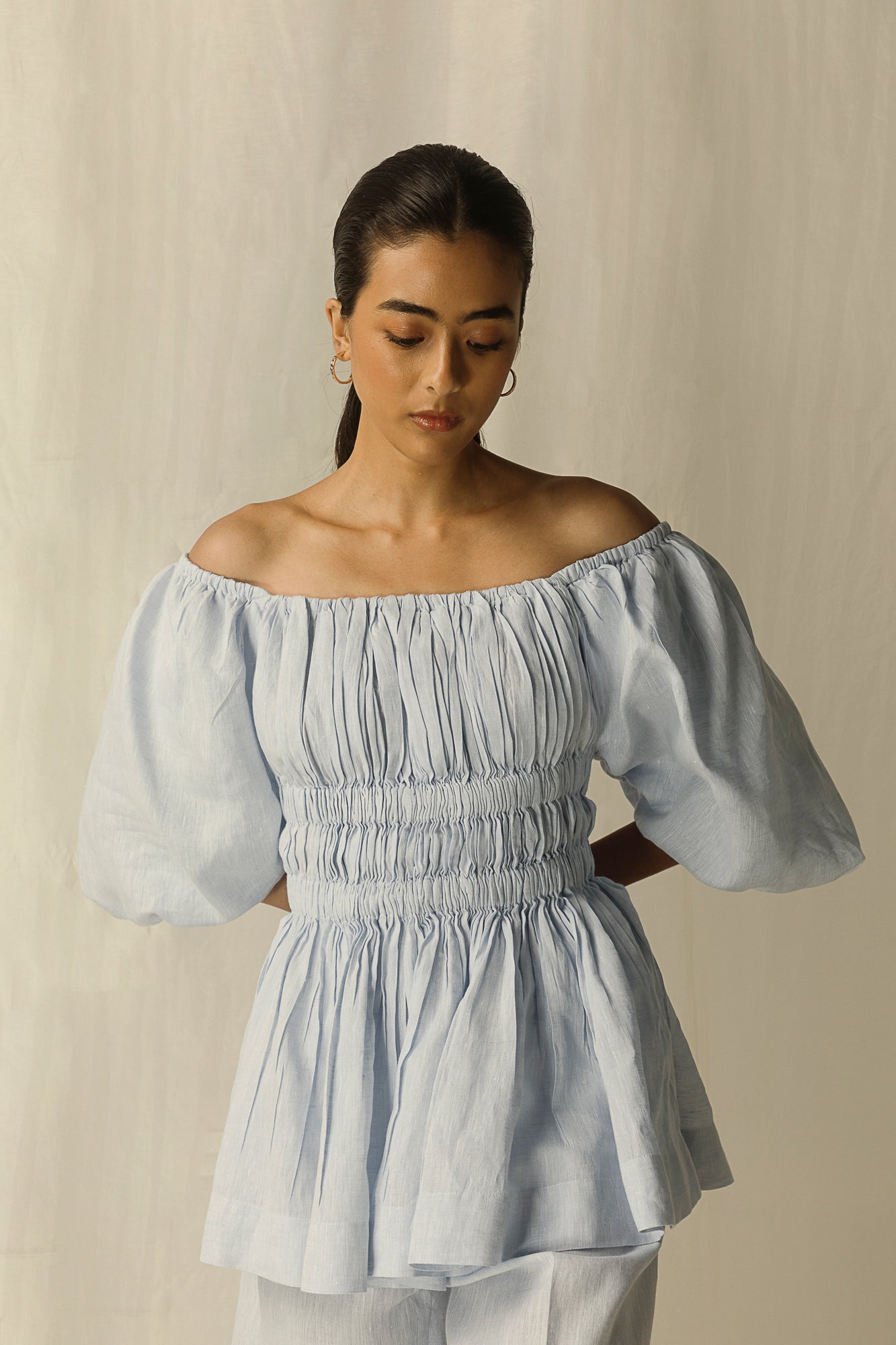 Elegant sky-blue top with a chic silhouette, crafted from premium handloom fabric, epitomizing luxury womenswear by NJ3 Atelier