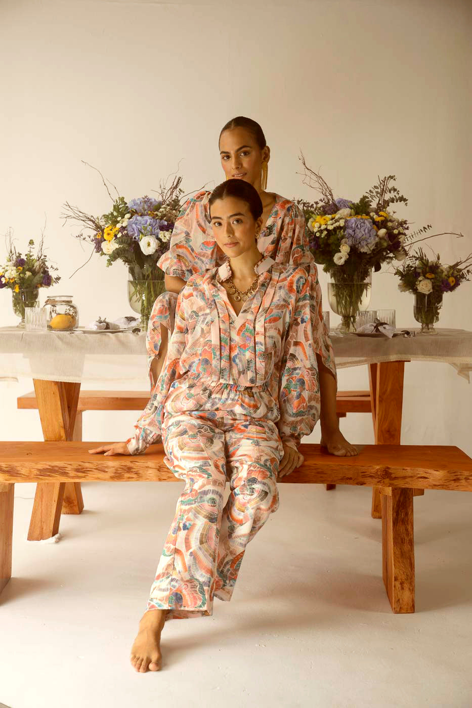 Luxurious wide-leg trousers in pure crape silk with an artisan Sufi print, featuring a straight silhouette in orange, brown, pink, and blue